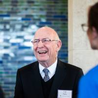 A guest smiling at the Thompson event.